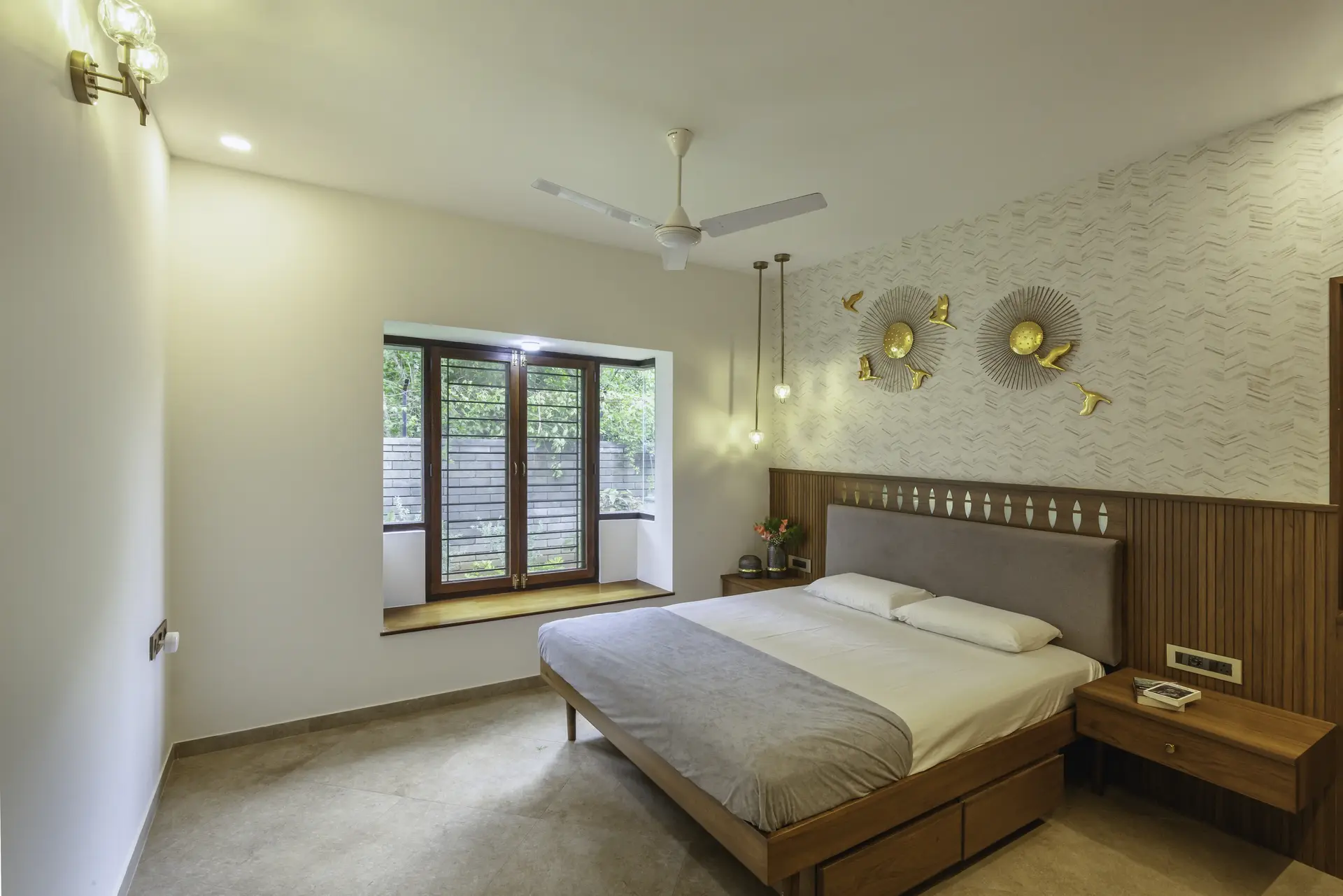 Bedroom with grey headboard and golden decor pieces